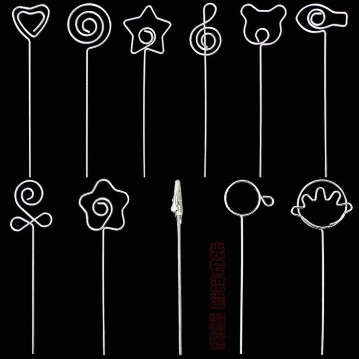 a bunch of white lollipops on a black background