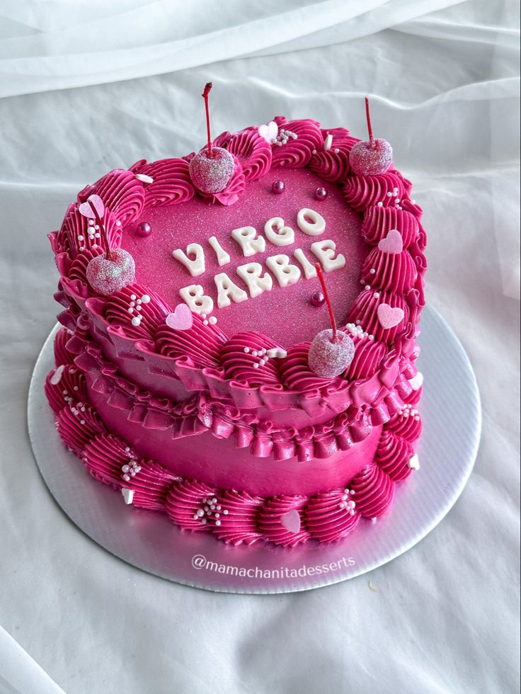 a pink heart shaped cake with the words virgo baby on it's side