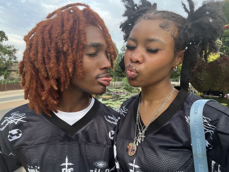 two young women standing next to each other with their mouths open and tongue hanging out