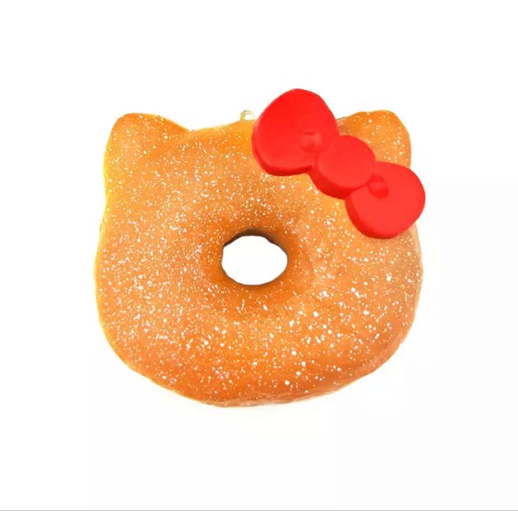 there is a donut with a bow on it and two red buttons in the middle