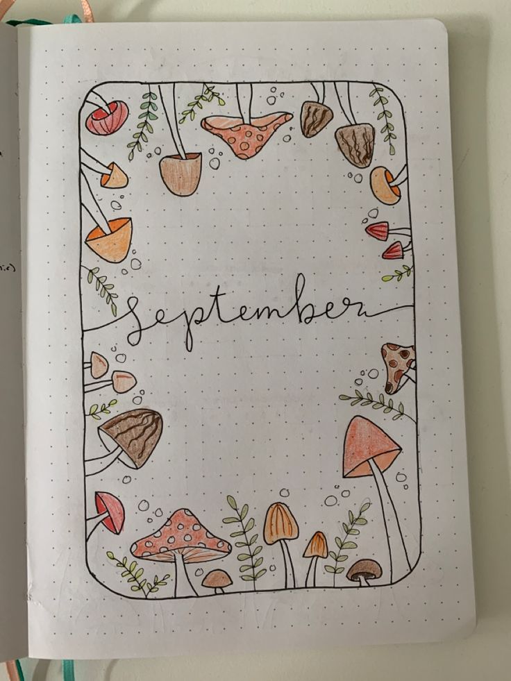 an open notebook with the words september written on it and various mushrooms, plants and leaves