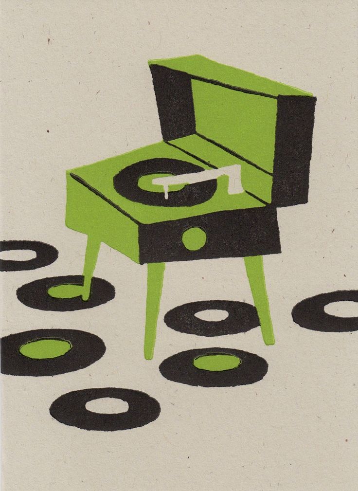 a green record player sitting on top of a table