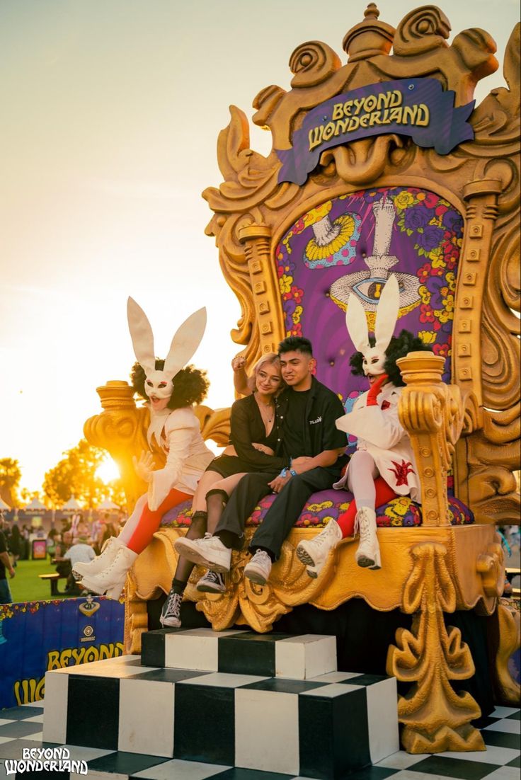 two people sitting on top of a giant chair with bunnies in the shape of rabbits