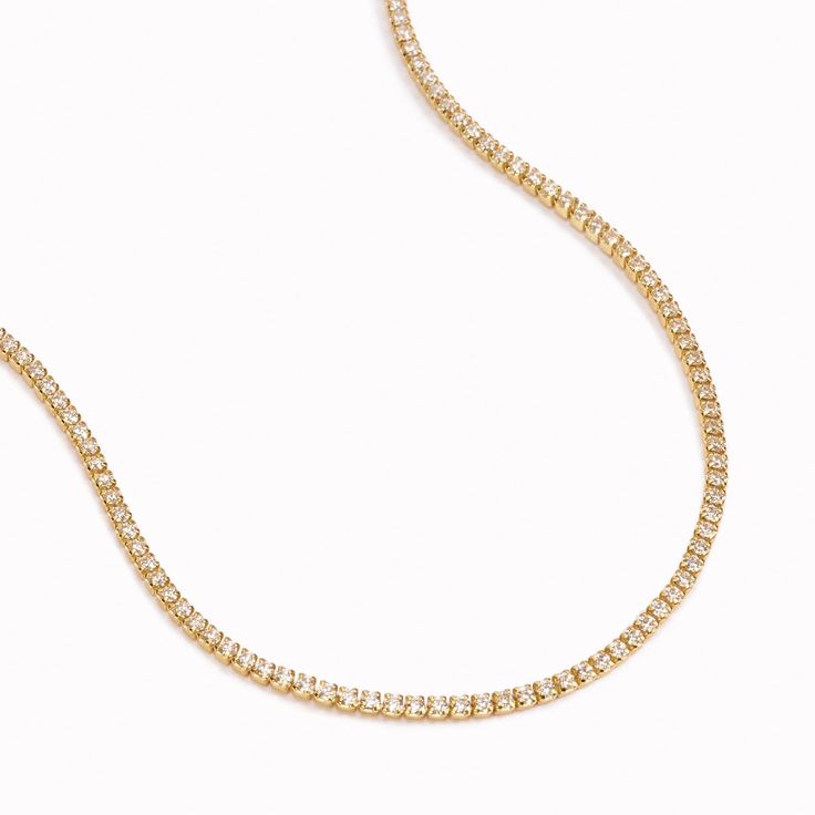 MB Tennis Necklace plated with 18K gold boasts a timeless style that is perfect for any occasion. Crafted from silver and plated with gold, it exudes an elegant and sophisticated look. Whether worn on the court or for a special event, this necklace is sure to make a statement. Premium Silver, 2 - 2.5 mm Zirconium stones, Length 40-42 cm. Formal White Gold Tennis Necklace With Chain, Elegant Single Strand Gold Bridal Necklace, Elegant Gold Single Strand Bridal Necklace, Elegant Formal Tennis Necklace With Clavicle Chain, Classic Box Chain Necklaces For Wedding, Classic Wedding Necklaces With Box Chain, Classic Wedding Box Chain Necklaces, Classic Wedding Chain Necklace, Classic Wedding Necklace With Chain