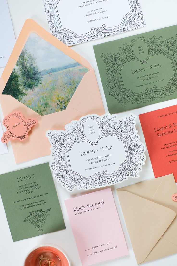 the wedding stationery is laid out on top of each other, including cards and envelopes