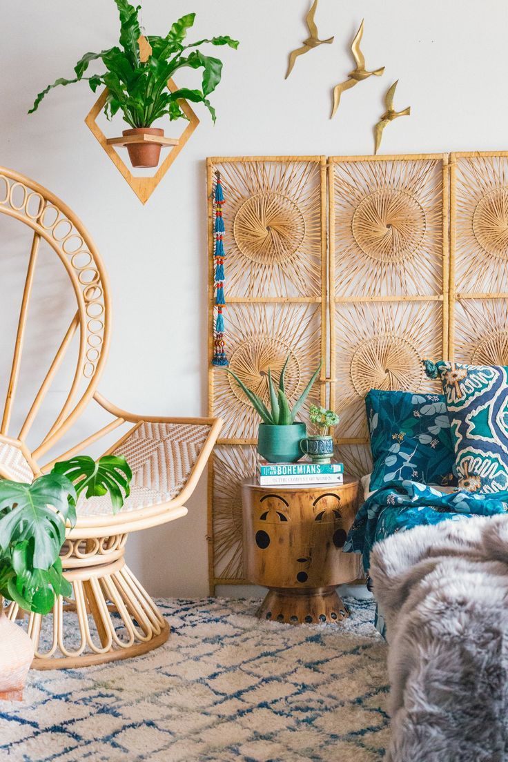 a bed room with a neatly made bed and plants