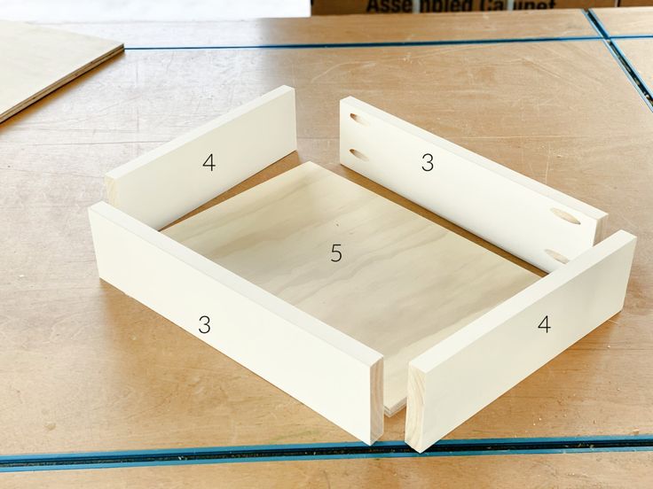 an unfinished drawer is shown with measurements for the bottom and side drawers in place on the table