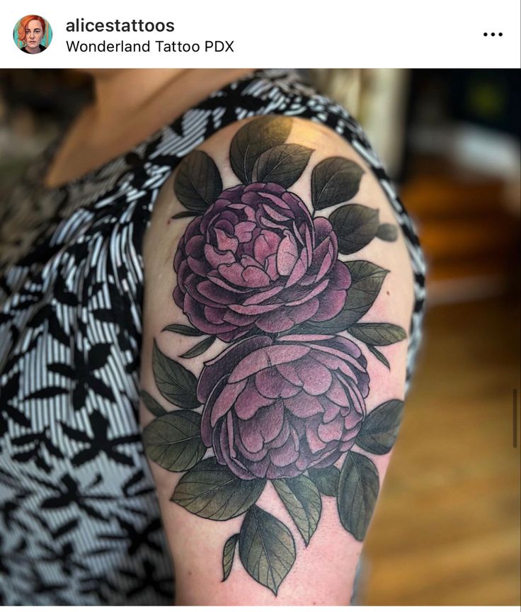 a woman with a flower tattoo on her arm