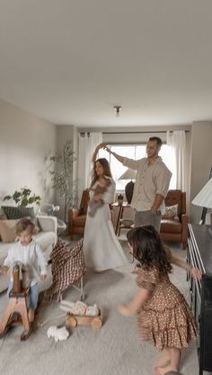 a man and two children are playing in the living room