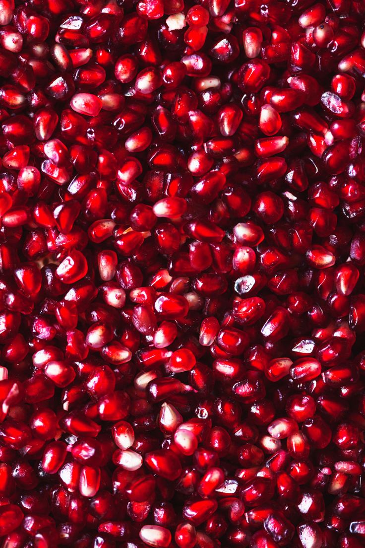 red pomegranates are shown in this close up photo, with the top portion