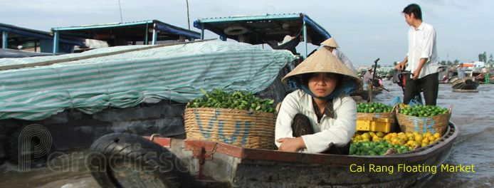 a woman sitting in a boat filled with fruit