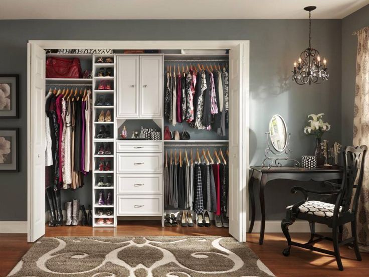 an open closet with clothes hanging on it