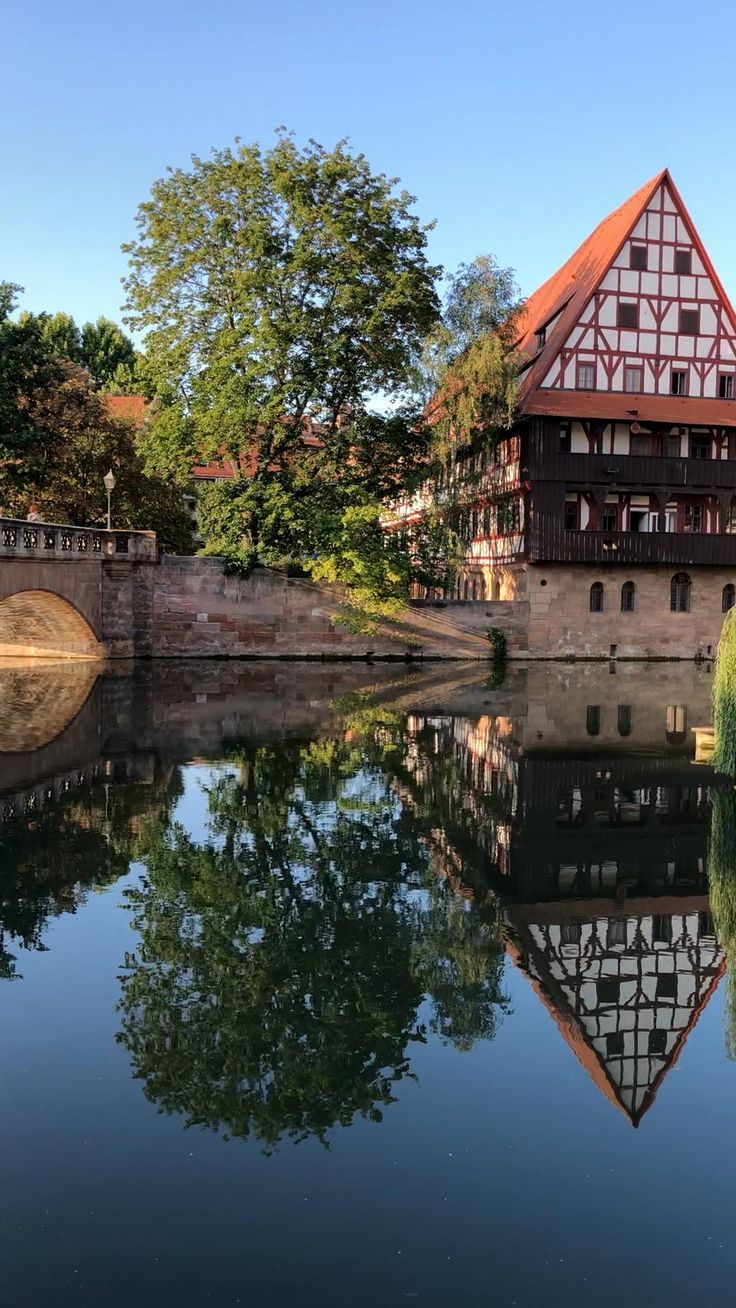 an old building is reflected in the water