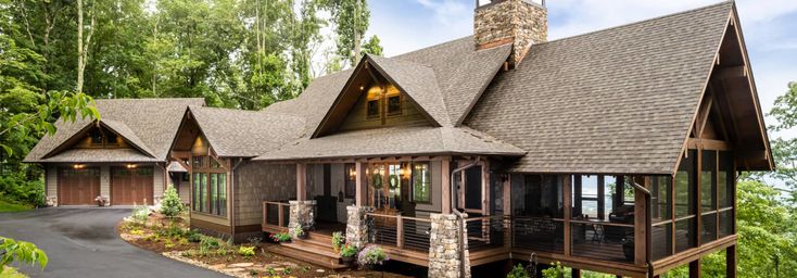 a large house in the woods with lots of windows