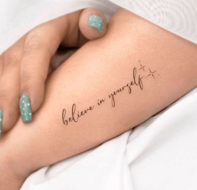 a woman's arm with the words believe in yourself tattooed on her left side