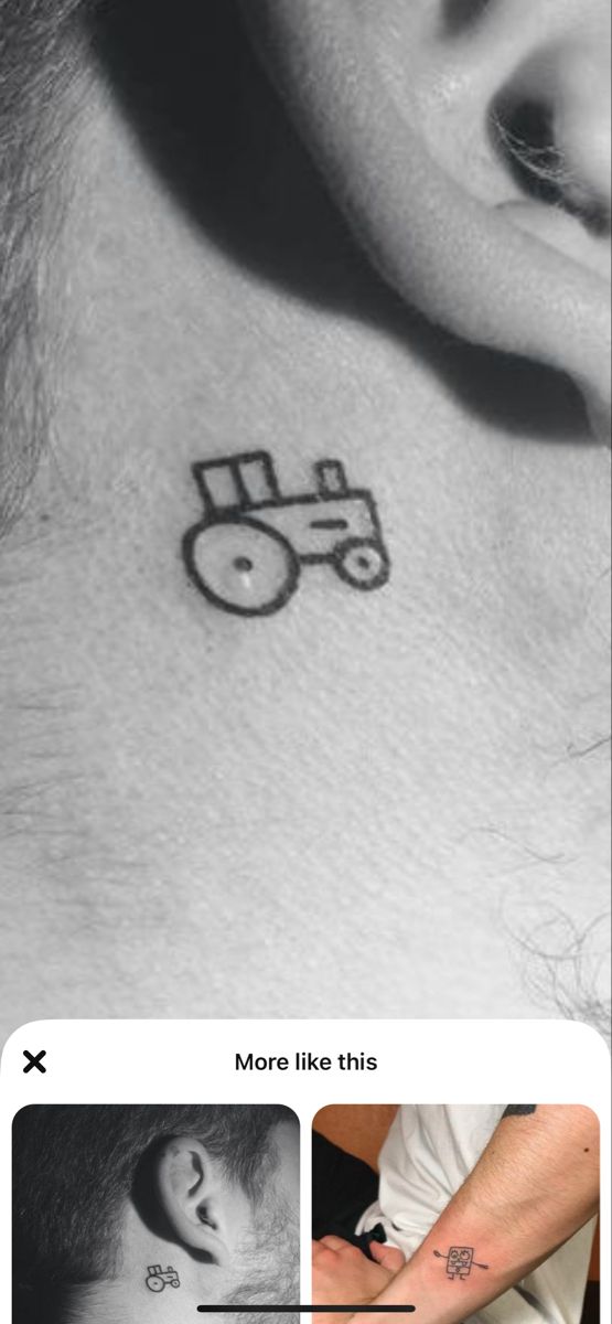 an ear tattoo with a tractor drawn on it