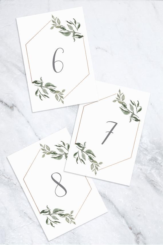 three place cards with green leaves on them and the numbers six, nine, seven