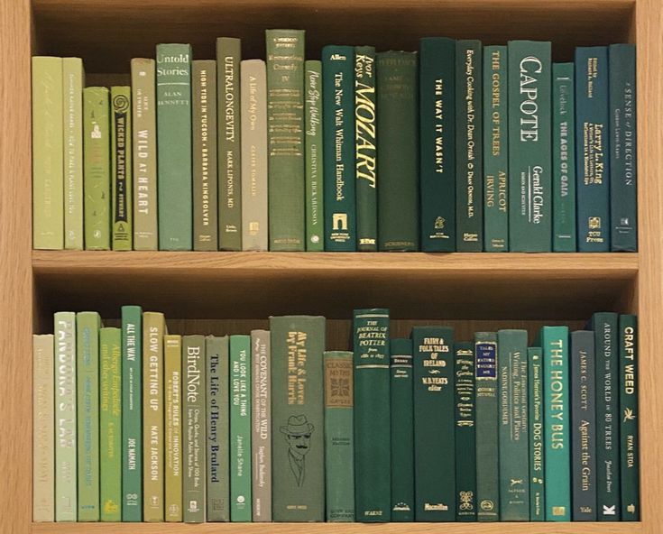 a book shelf filled with lots of green books