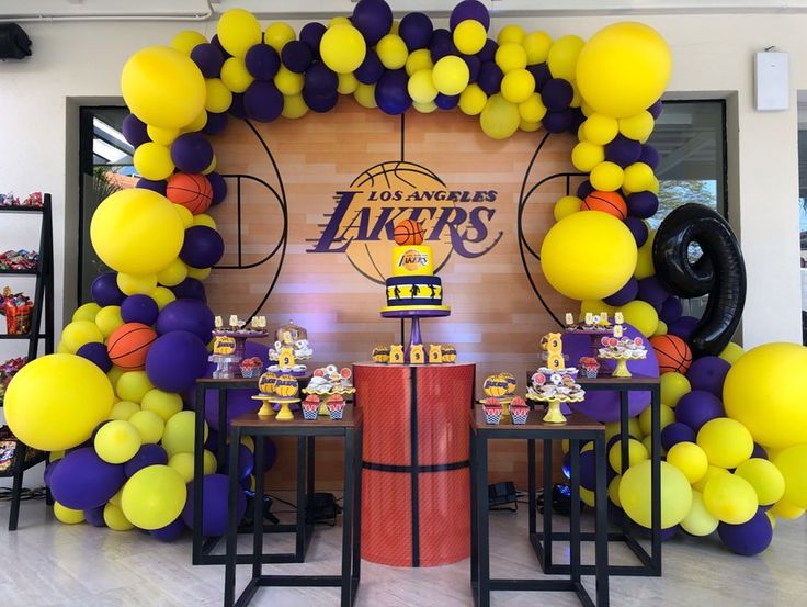 a basketball themed birthday party with balloons and table decorations for the lakers team's game