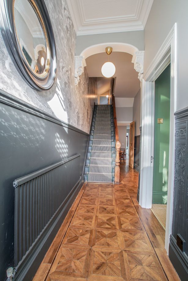 an image of a house with stairs in the hallway and a mirror on the wall