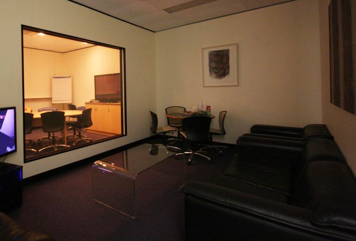 a living room filled with furniture and a flat screen tv