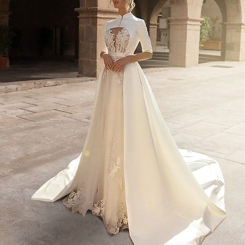 a woman in a wedding dress standing outside