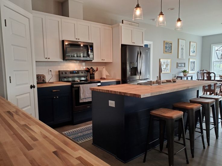 a kitchen with an island and bar stools