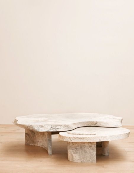 a white table sitting on top of a hard wood floor next to a beige wall