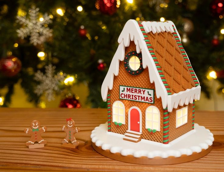 a gingerbread house with christmas decorations around it