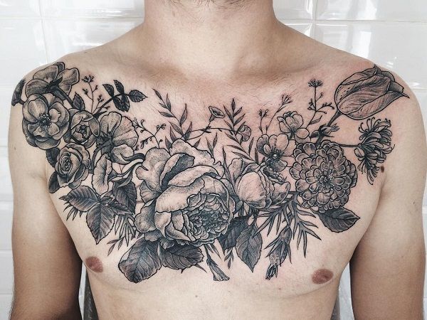 a man's chest with flowers and leaves tattooed on his upper half - body