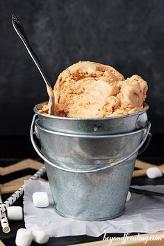 a bucket filled with ice cream sitting on top of a table