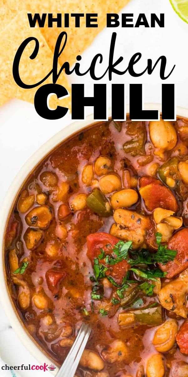 white bean chicken chili in a bowl with a spoon and tortilla chips on the side