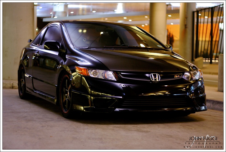 a black car parked in front of a building