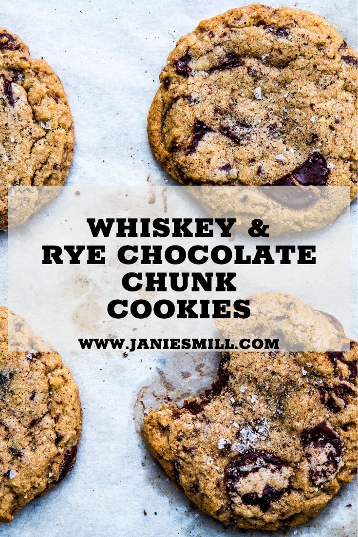 four chocolate chip cookies with the words whiskey and rye chocolate chunk cookies