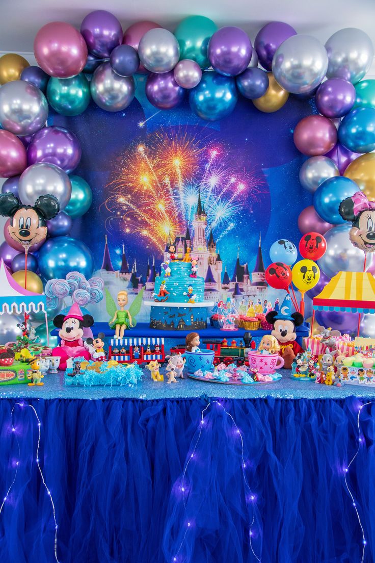 a birthday party with balloons and mickey mouse decorations