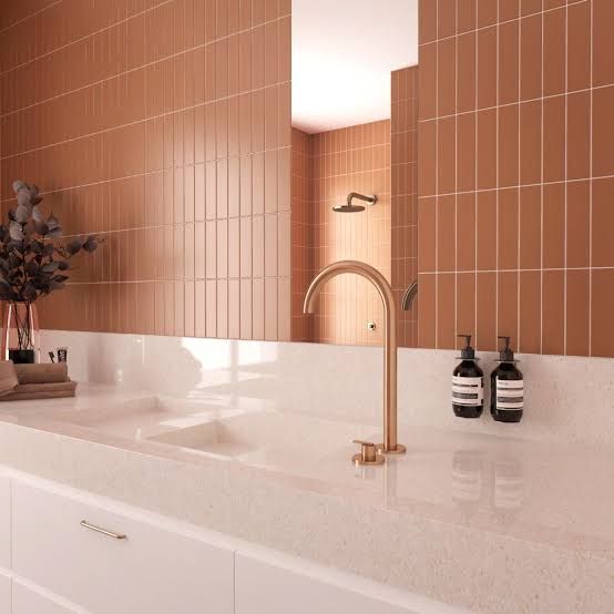 a bathroom sink with two faucets and soap dispensers