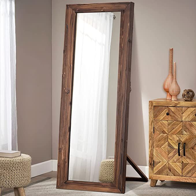 a large mirror sitting on top of a wooden dresser