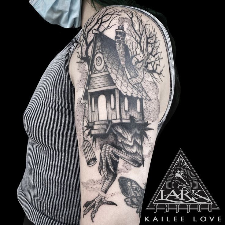 a woman with a bird house tattoo on her arm