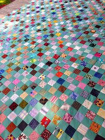 a patchwork quilt is laying on the ground