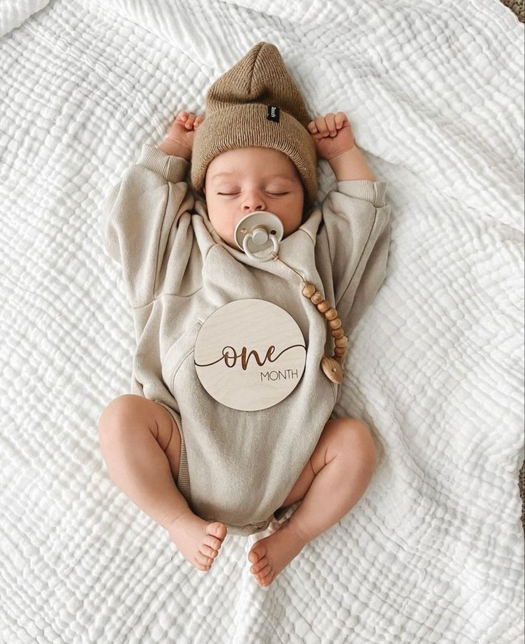 a baby is sleeping on a bed with a pacifier in it's mouth