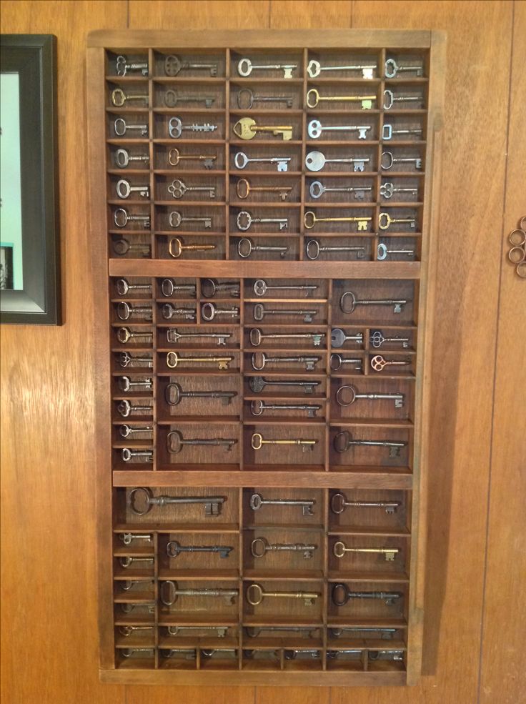 a wooden door with lots of keys on it