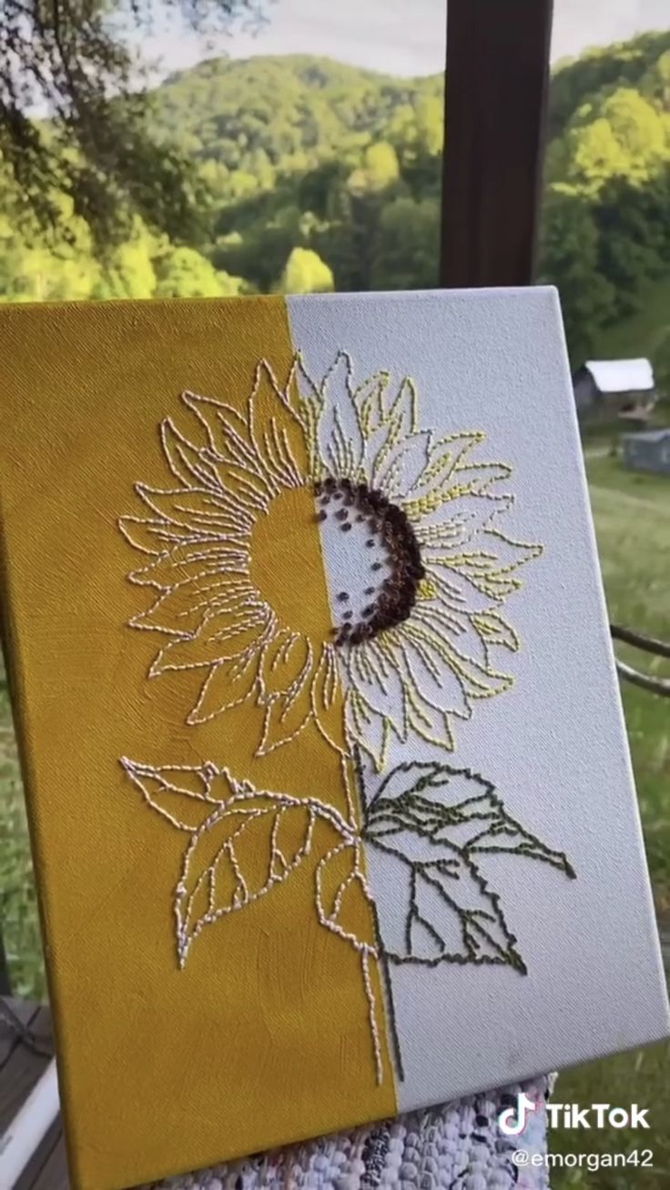 a yellow and white canvas with a sunflower on it