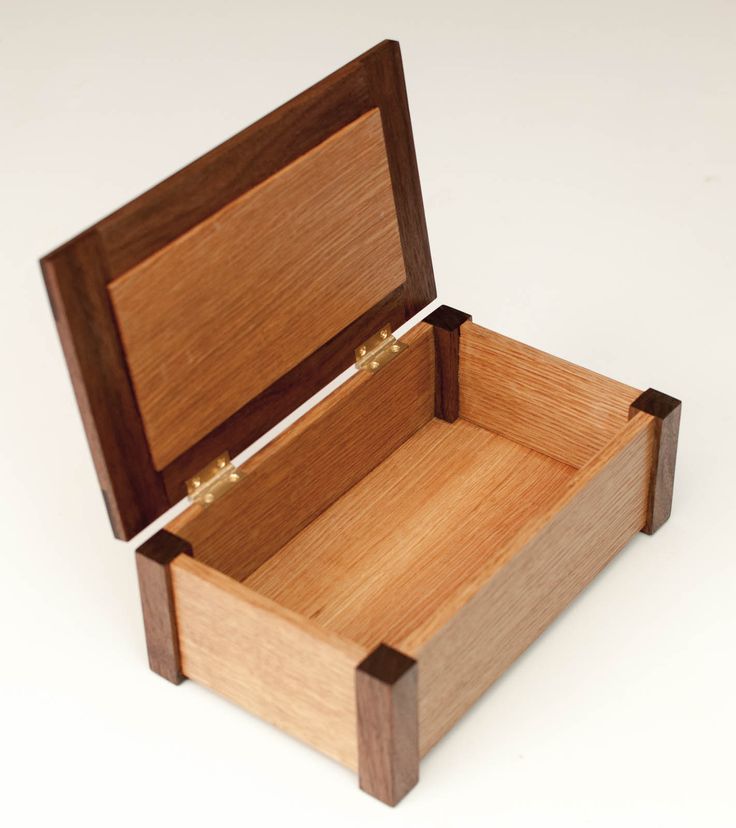 an open wooden box on a white surface