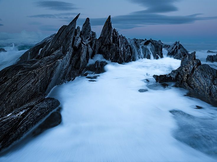 the rocks are covered in snow and water