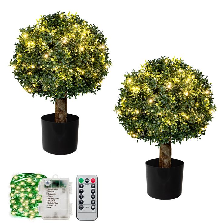 two potted trees with lights and remote control