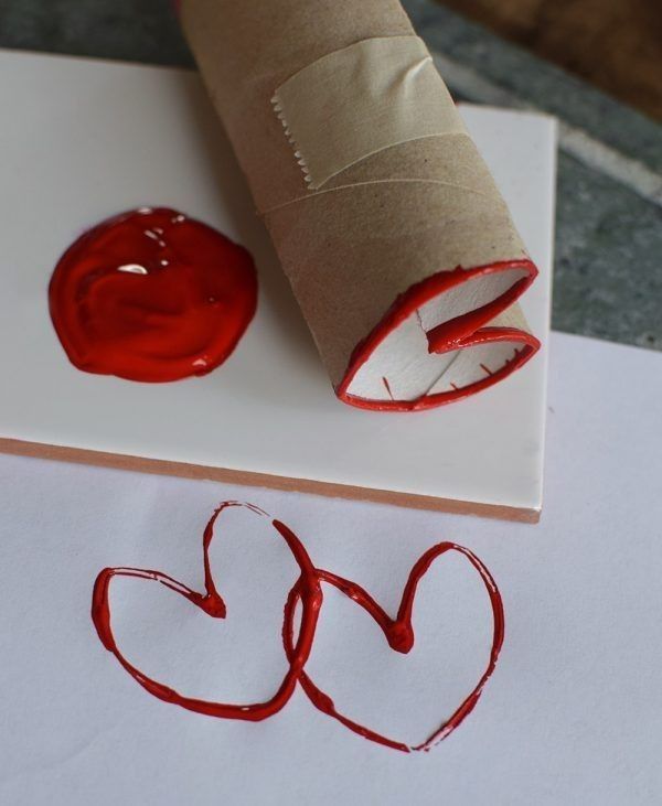 a rolled up piece of paper sitting on top of a sheet of paper next to a red wax stamp