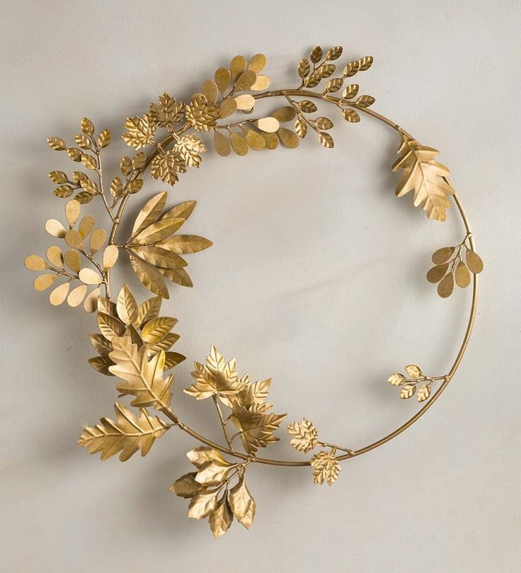 a gold metal wreath with leaves and acorns