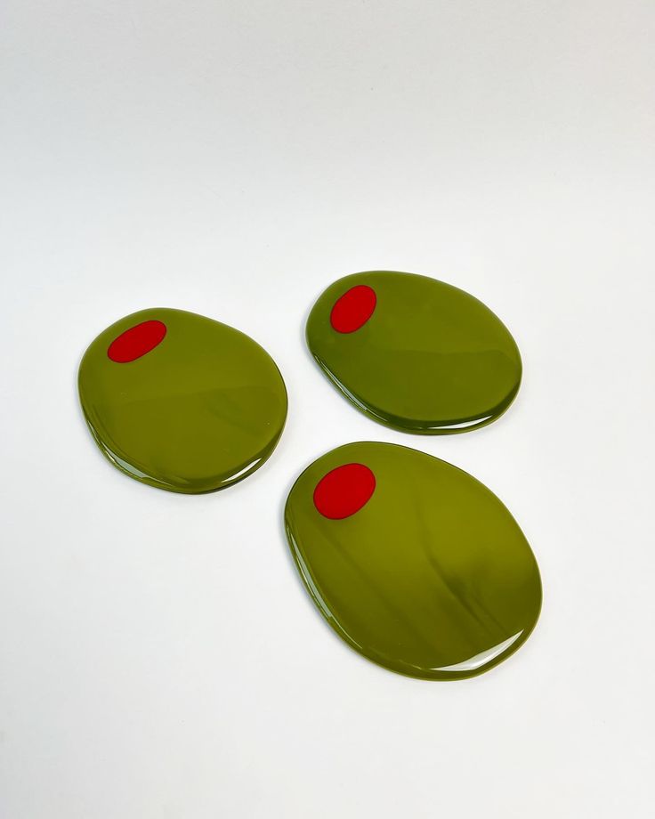 three green buttons with red dots on them