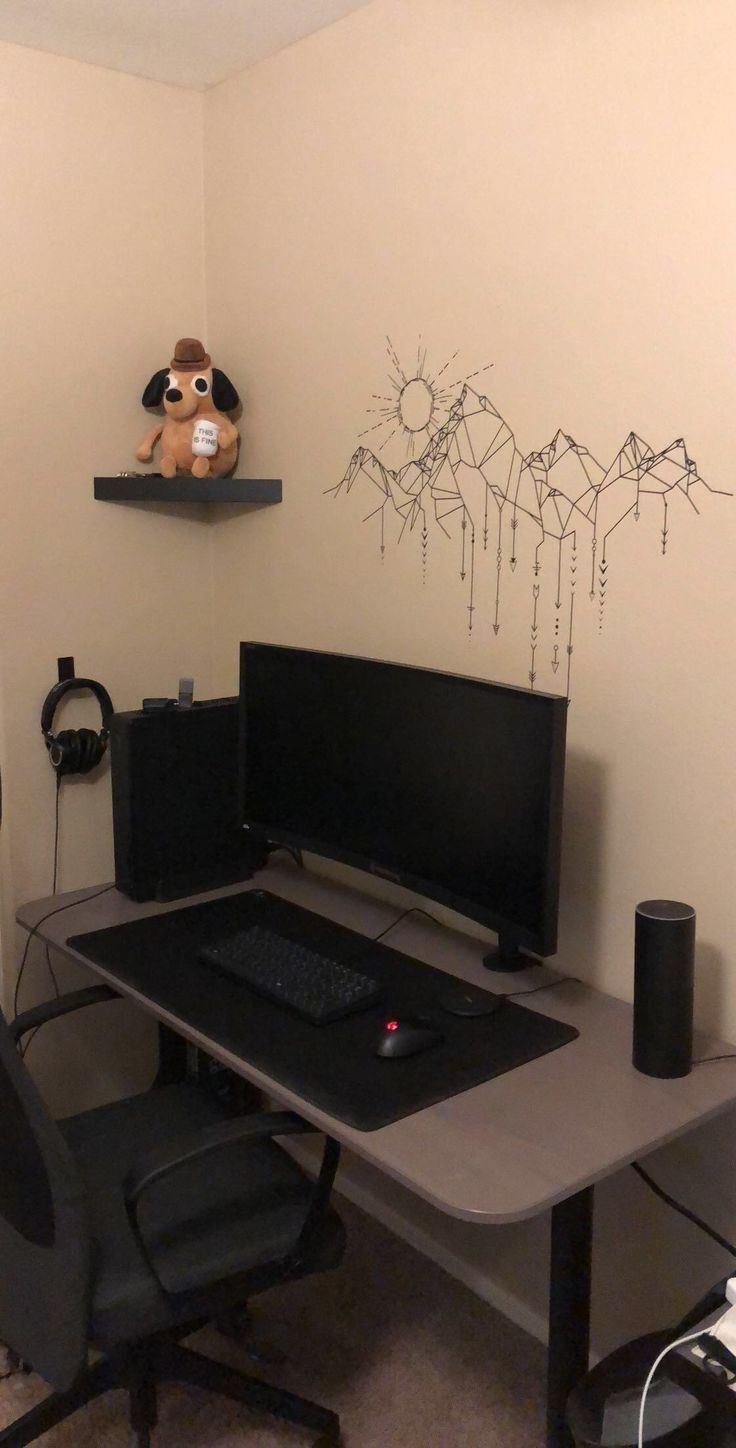 a computer desk with a monitor, keyboard and mouse on it in front of a white wall