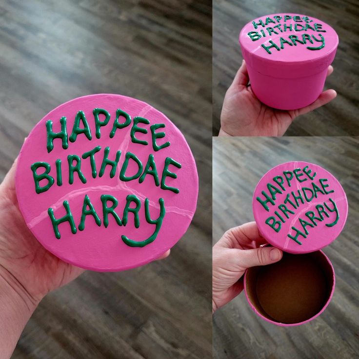 there is a pink birthday cupcake with happy birthday written on the top and bottom